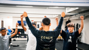 YPL Classes A coach teaching trainees in a fitness room